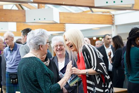 Women at an event chatting and laughing
